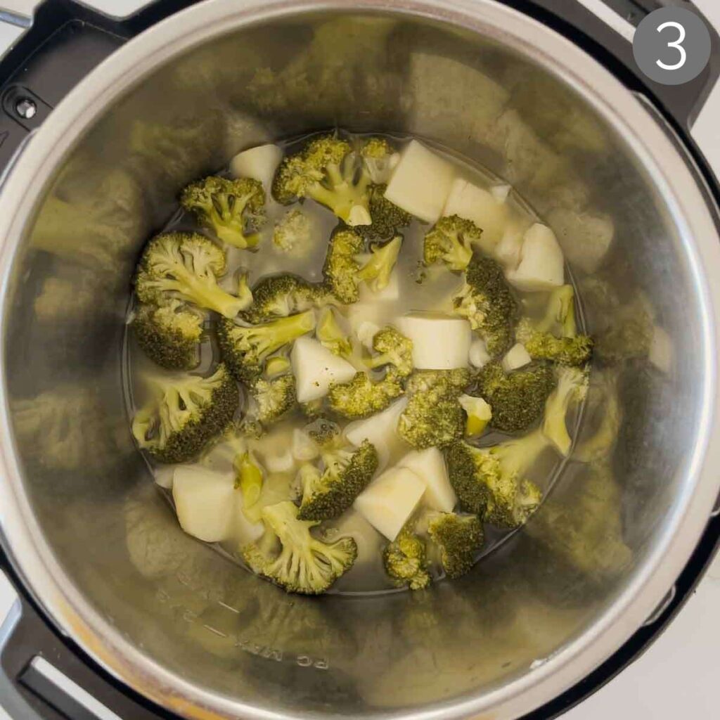 Broccoli florets, diced potato and chopped garlic after cooking in Instant Pot for making broccoli soup. 