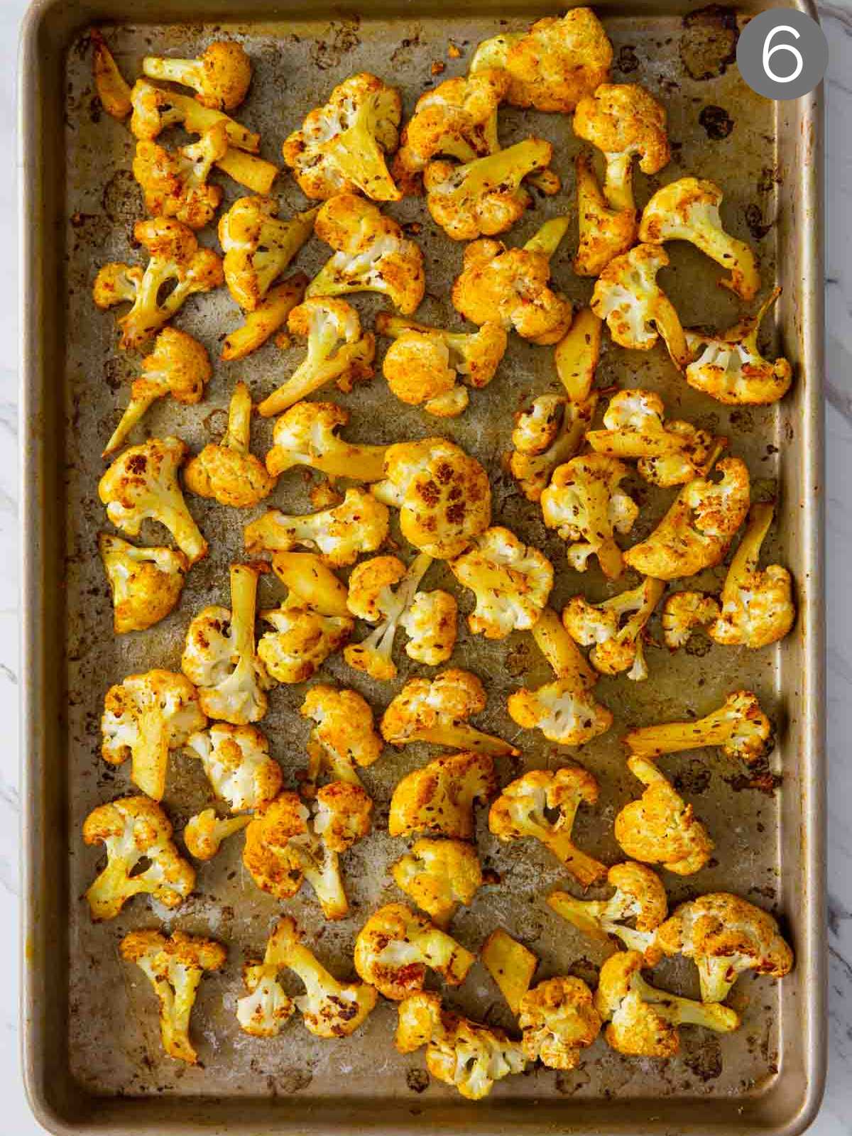 Turmeric roasted cauliflower on a baking tray after baking is complete.