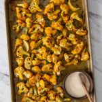 Turmeric roasted cauliflower with tahini sauce Pinterest small pin with text overlay.