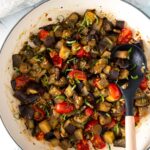 Image of sauteed eggplant and tomatoes in a large skillet with text over that reads 'healthy quick and easy sauteed eggplant'.