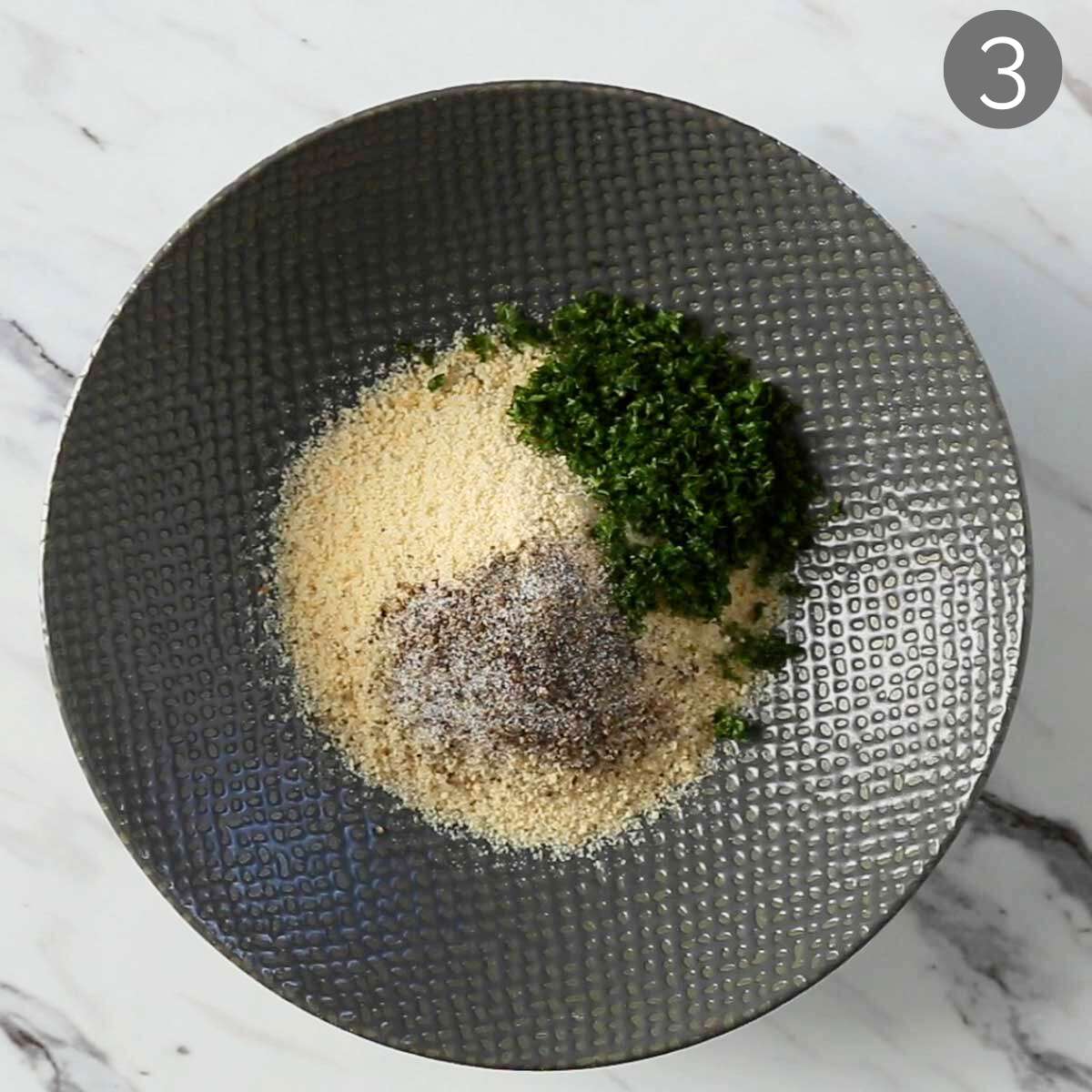 Breadcrumbs with herbs and seasonings in a mixing bowl ready to mix.