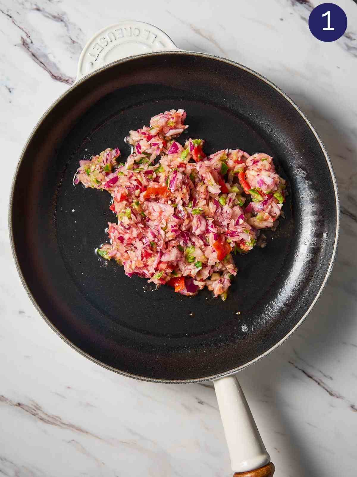 Chopped onion, tomato, garlic and jalapeno mixture in a hot pan.