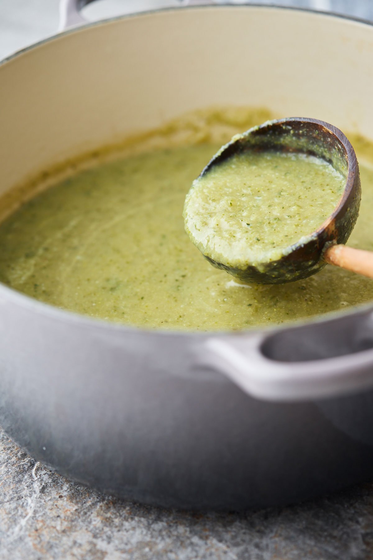Blended soup in a pot with a serving ladle.