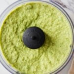 Text overlay on a pin showing "Healthy Green Pea Easy Hummus" with a photo of blended green pea hummus in a food processor jar.
